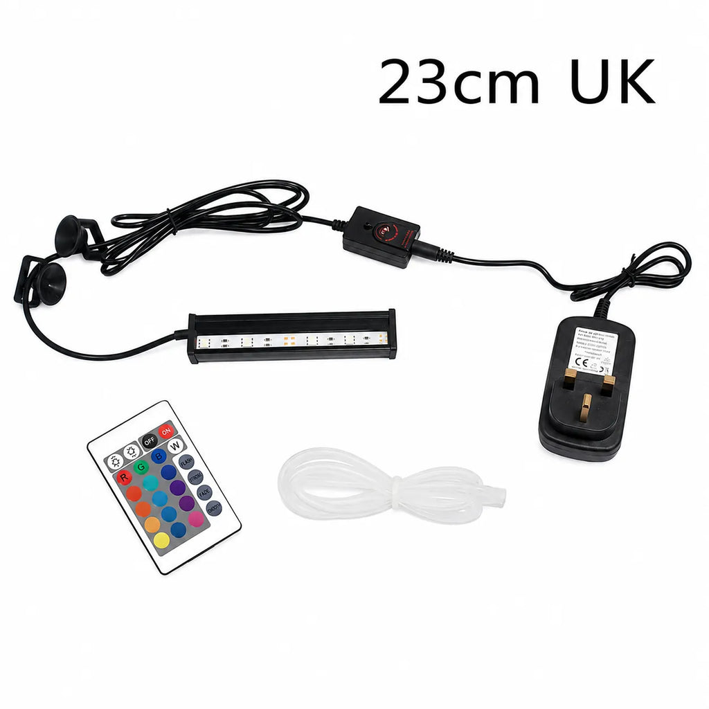 23cm UK RGB LED aquarium light bar kit with UK 3-pin plug, remote control, suction cup mounts, controller, and clear airline tubing displayed on a white background.