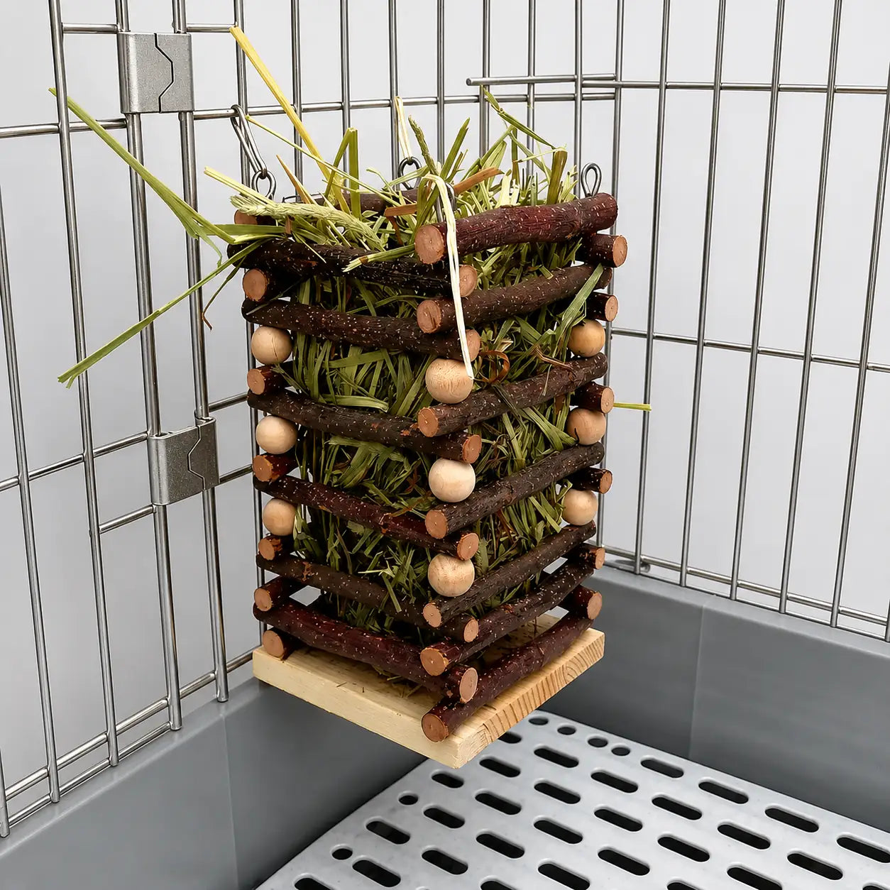 Natural wooden hay feeder inside a metallic pet cage. Durable hanging hay rack for rabbits, guinea pigs, and other small pets to reduce waste and keep hay clean.